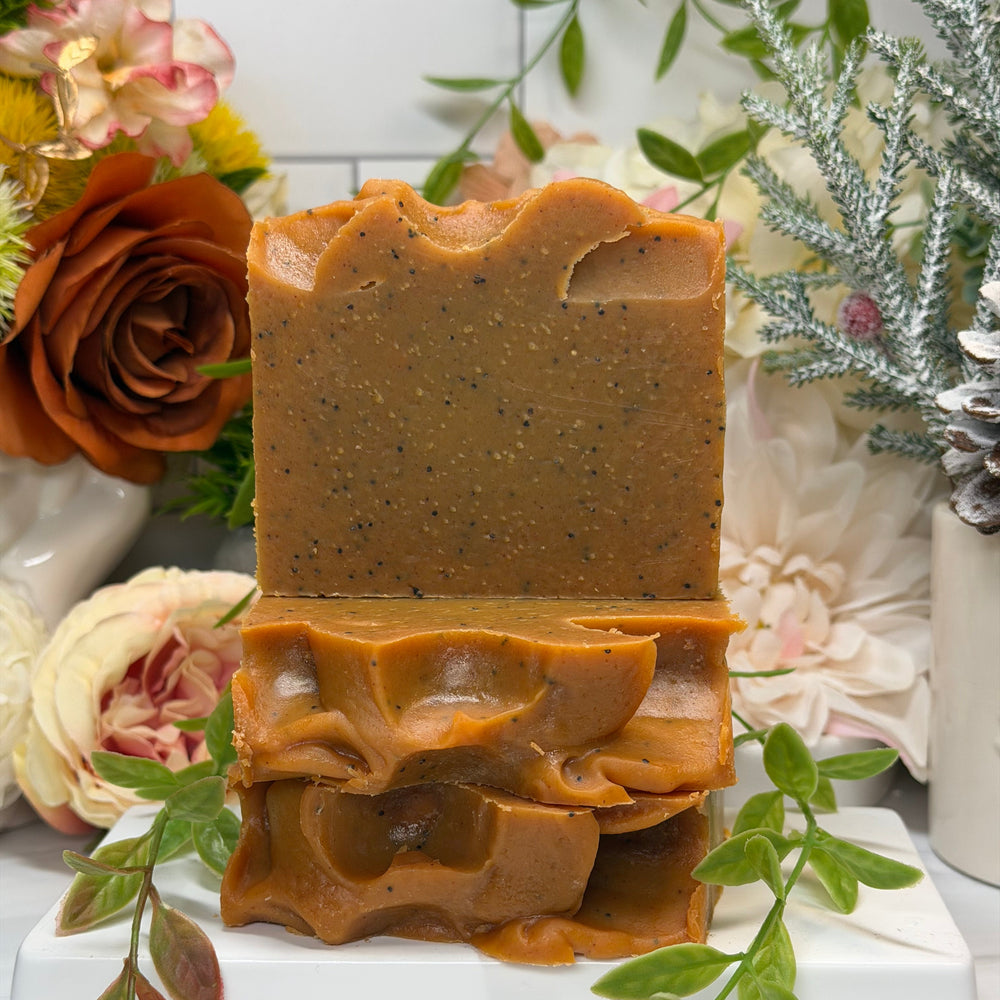 Brown soap bar with decorative elements on a white surface