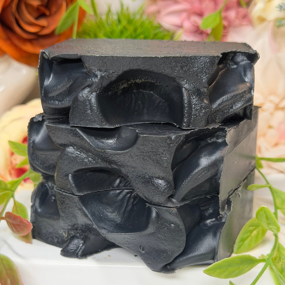 Black soap bar with floral and green leaf background