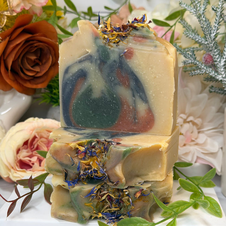 Handmade soap with natural elements on a decorative background with flowers and greenery