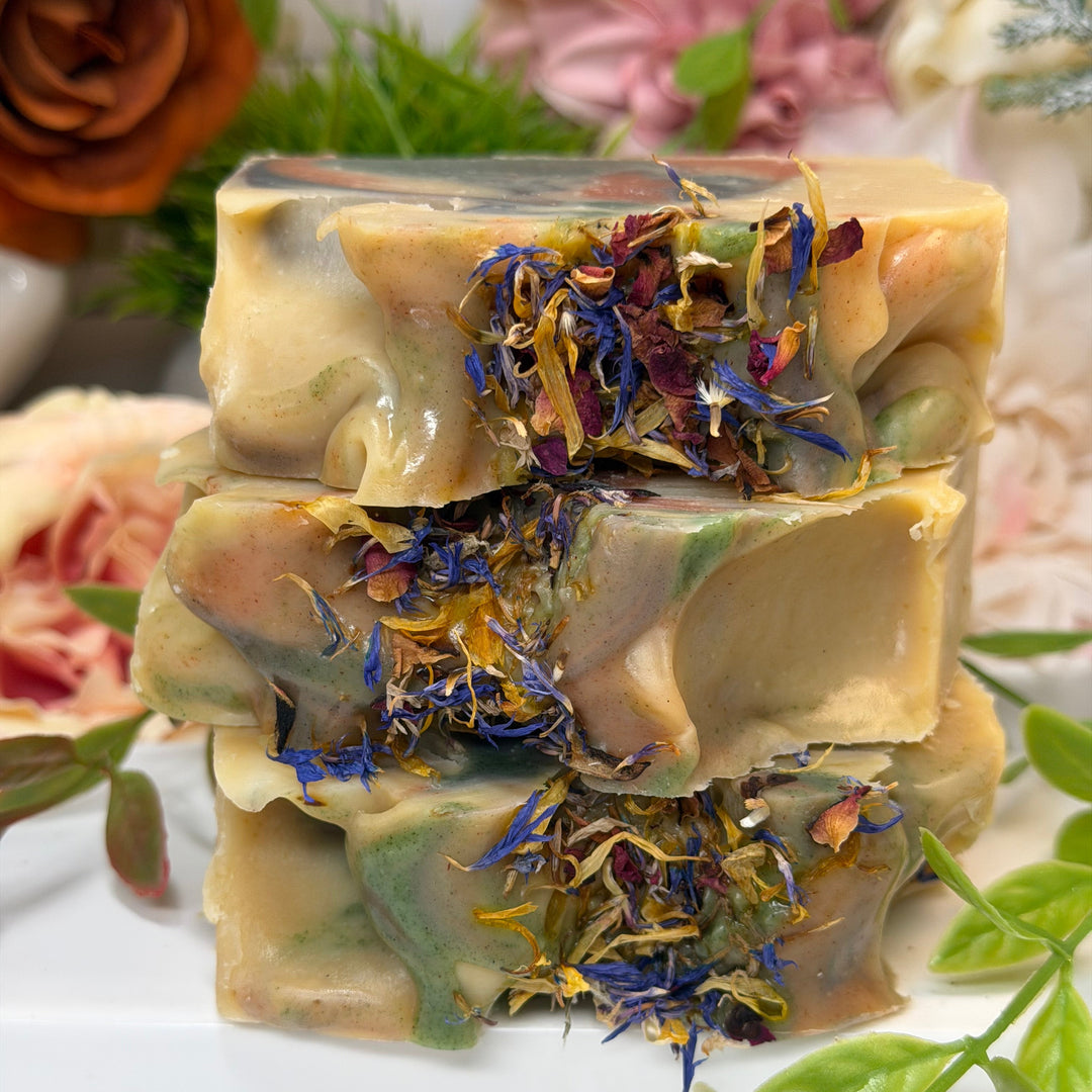 Handmade soap with natural ingredients and flowers on a white background