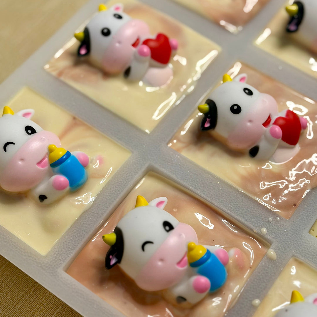 Set of cow-themed stickers on a clear sheet with a beige background
