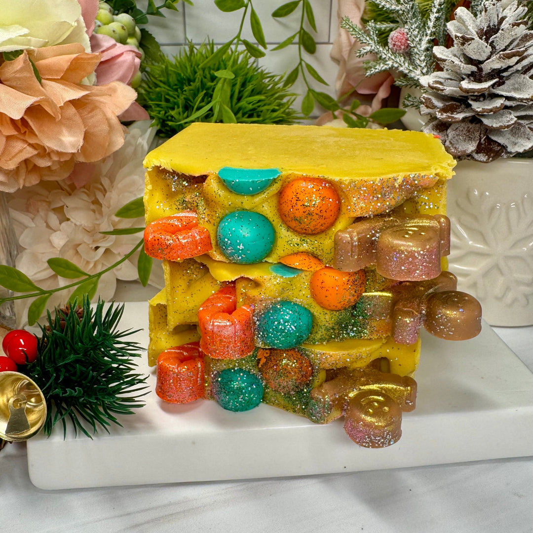 Colorful layered soap in yellow with ginger bread and candy cane decor