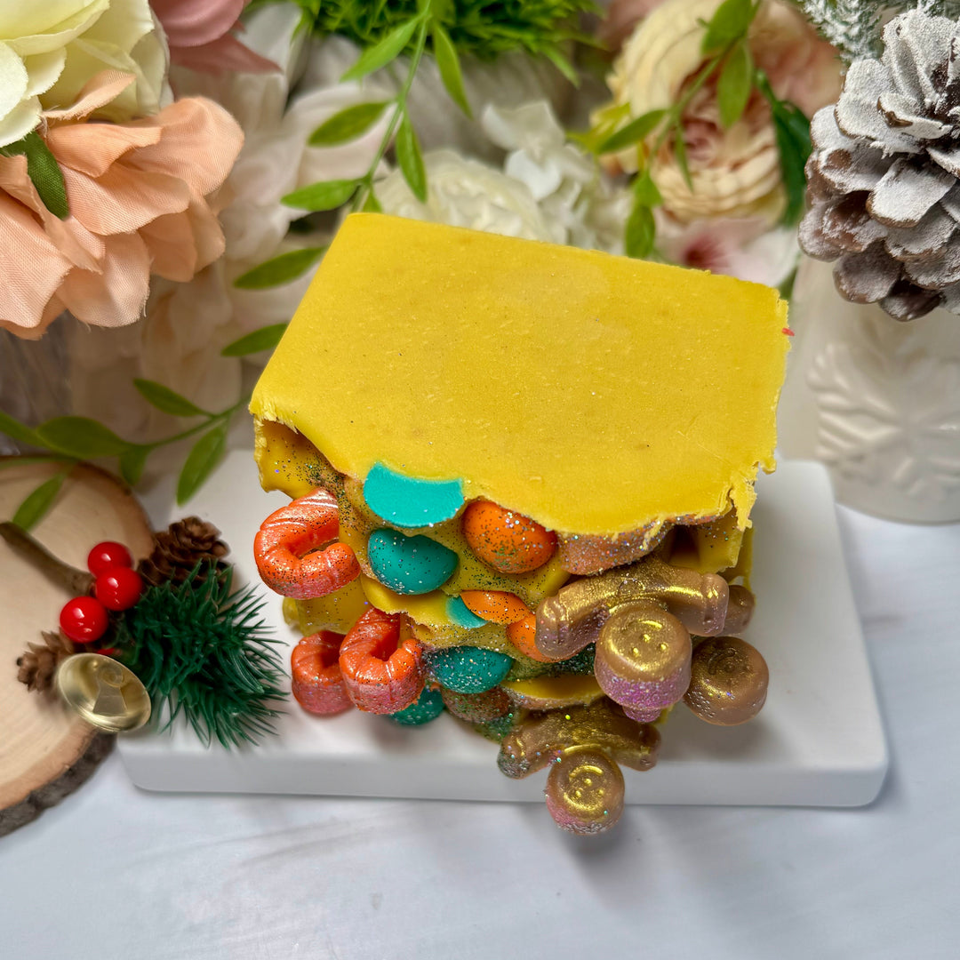 Colorful layered soap in yellow with ginger bread and candy cane decor