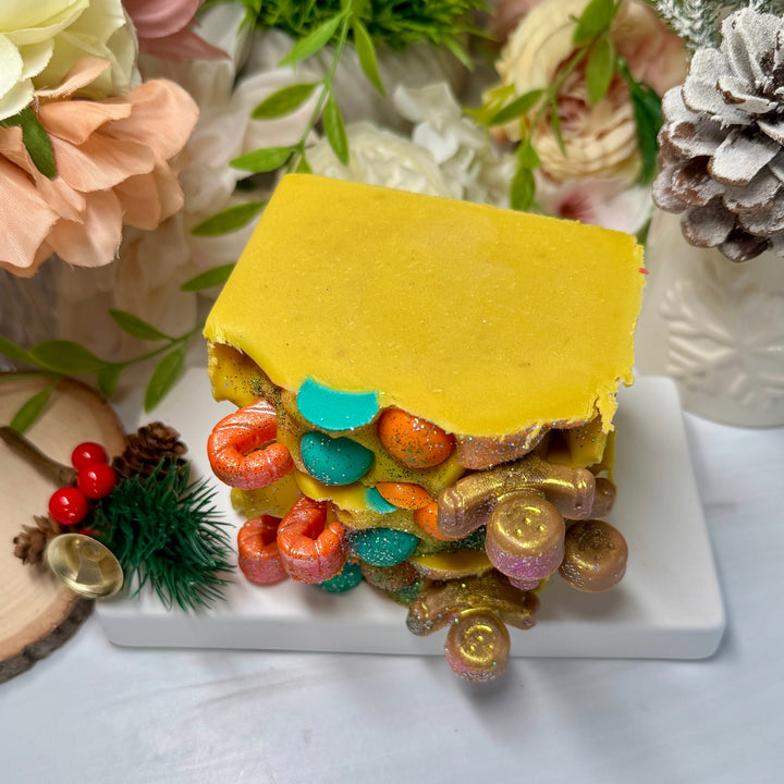 Colorful layered soap in yellow with ginger bread and candy cane decor