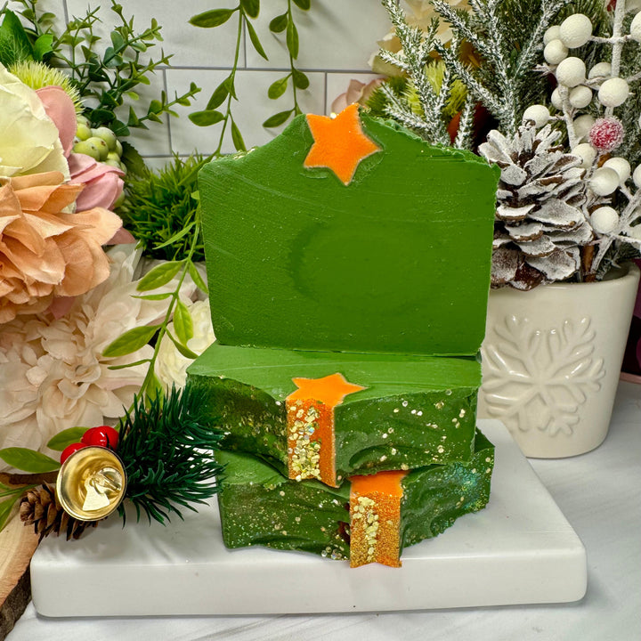 Green soap with gold accents on a white surface with decorative elements