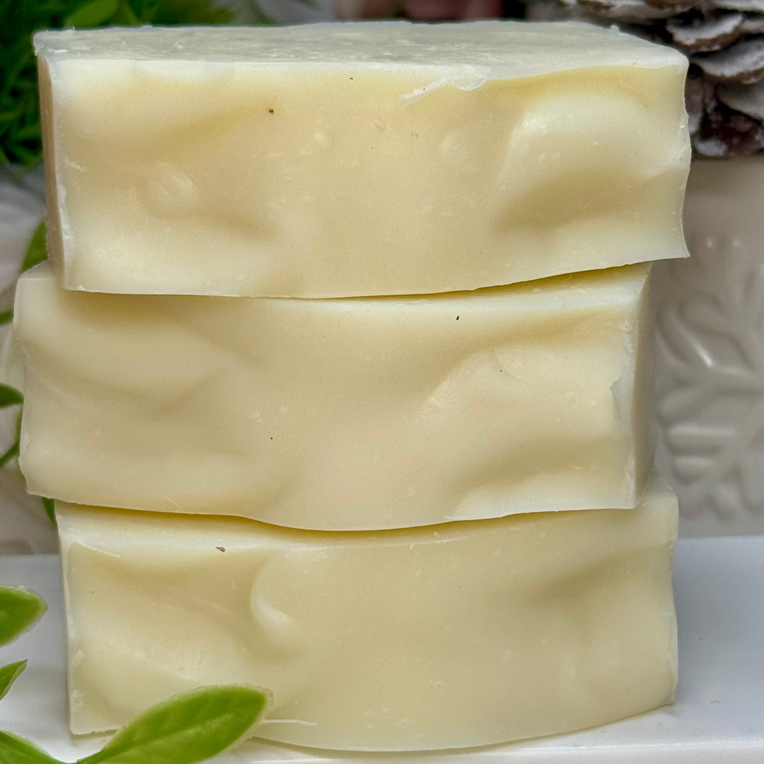 Stack of three bars of soap with a natural background