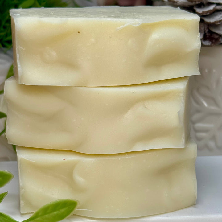 Stack of three bars of soap with a natural background